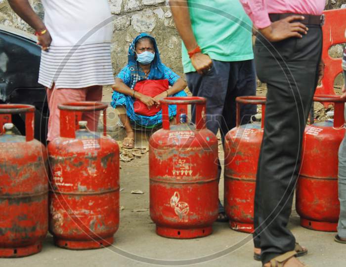 People wait in a queue to purchase cooking gas after India ordered a 21- day nationwide lockdown to limit the spreading of coronavirus disease (COVID-19) in Mumbai, India on March 27, 2020.