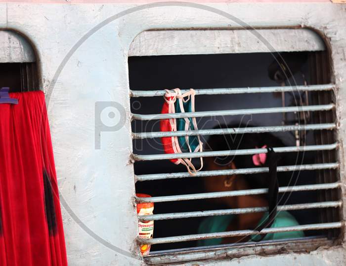 Migrants Hang face Masks At a Train Window while Travelling on a Special Train During Extended Nationwide Lockdown Amidst Coronavirus Or COVID-19 Pandemic in Prayagraj