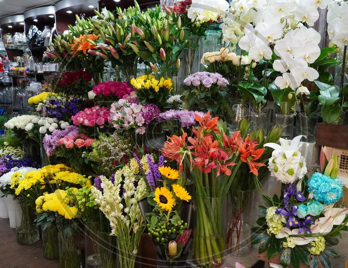 Bouquet Of Colorful Roses And Other Different Flowers At The Entry To Flower Shop At Farmers' Market. Colorful Peony, Roses Etc. Pots With Flowers On The Shelf Of Plant Shop. Dubai Uae December 2019