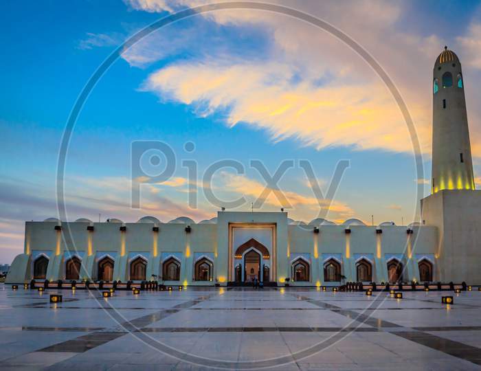 Imam Muhammad ibn Abd al-Wahhab Mosque (Qatar State Mosque) exterior view at sunset with clouds in the sky