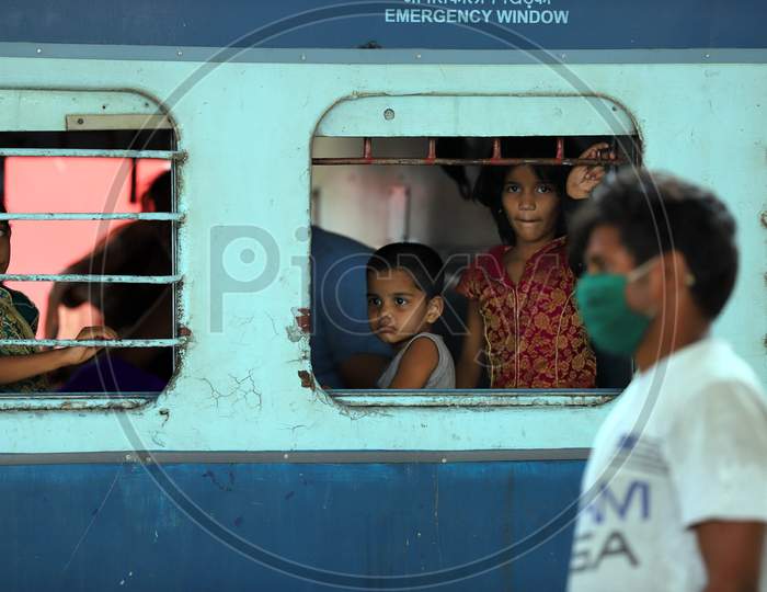 Migrant children peep out from the window of a Special Train During Extended Nationwide Lockdown Amidst Coronavirus Or COVID-19 Pandemic in Prayagraj