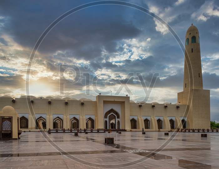 Qatar State Mosque (Imam Muhammad ibn Abd al-Wahhab Mosque) exterior view at sunset with clouds in the sky