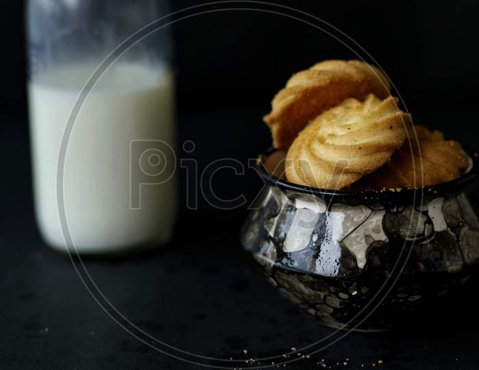 Butter Cookies In A Cookie Jar Served With Milk Bottle
