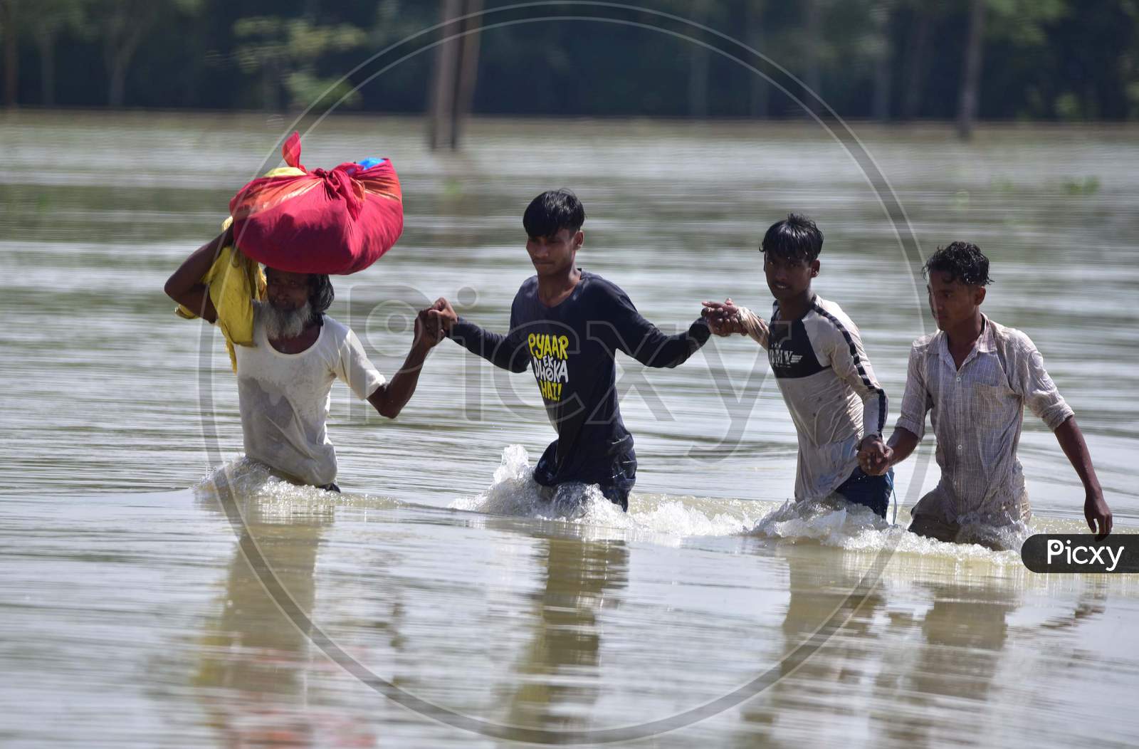 Villagers  Carrying Their  Belongings as they Shift To A Safer Place At  Flood-Affected Jamunamukh  Village In Hojai District Of Assam On May 29,2020