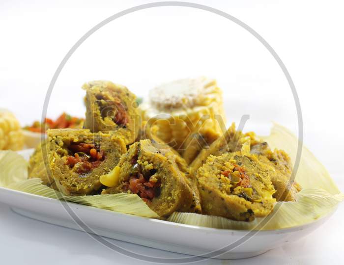 Muthiya is traditional Gujarati steam cooked food made from corn,fenugreek, carrot, besan and wheat flour and served with oil and chutney.healthy food