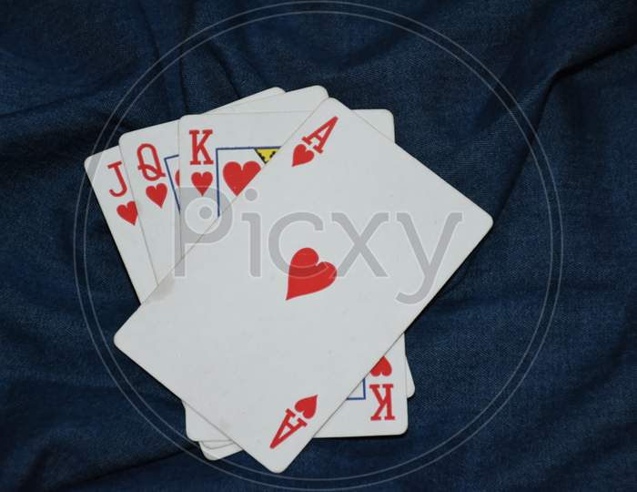 Deck of card in denim background . Playing cards . Ace of heart . king . Queen.