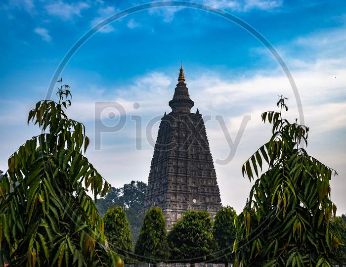 Buddhist Stupas Isolated With Bright Sky And Unique Prospective Image Is Taken At Mahabodhi Temple Bodh Gaya Bihar India. It Is The Enlightened Place Of Grate Budha And Very Religious For Buddhist.