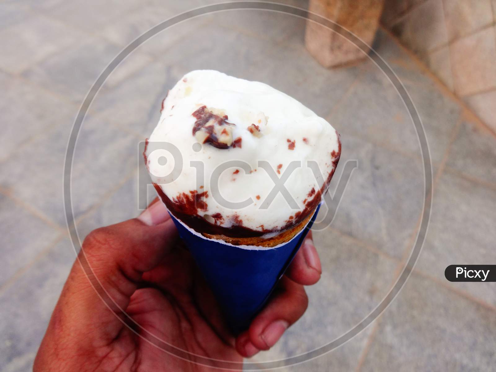 Whipped cream vanilla flavour chocolate ice cream in hand