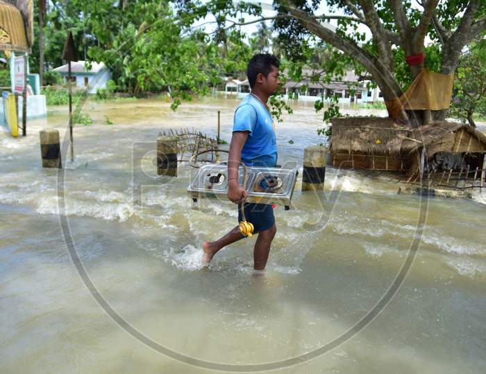 A Man Carrying his belongings Shifts To A Safer Place During Floods At Kampur  In Nagaon District Of Assam On , May 29, 2020.