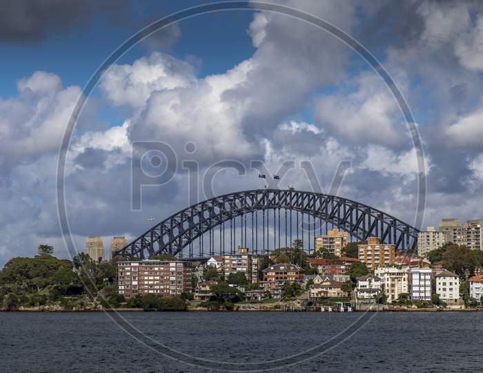 Sydney in Australia, taking pictures of the skyline with the Harbour Bridge during a cloudy but warm day.