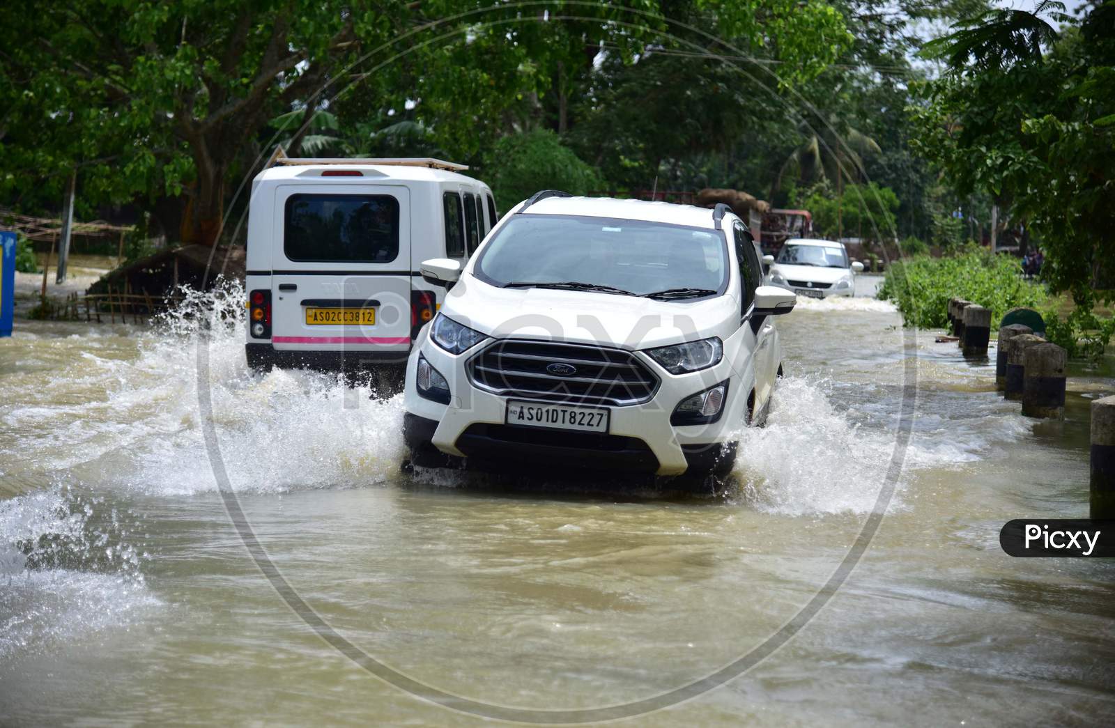Vehicles Moving On Road Through Flood Waters In Kampur In Nagaon District Of Assam On May 29,2020