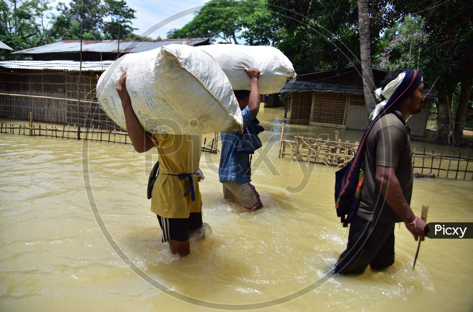 Villagers  Carrying Their Belongings Shift To A Safer Place During Floods At Kampur  In Nagaon District Of Assam On , May 29, 2020.