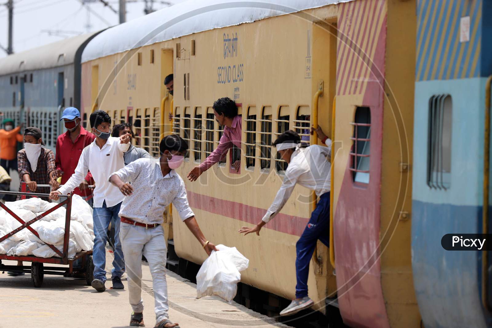 Migrants Taking Free Food At Prayagraj Junction During Extended Nationwide Lockdown Amidst Coronavirus Or COVID-19 Pandemic, Prayagraj On May 30,2020