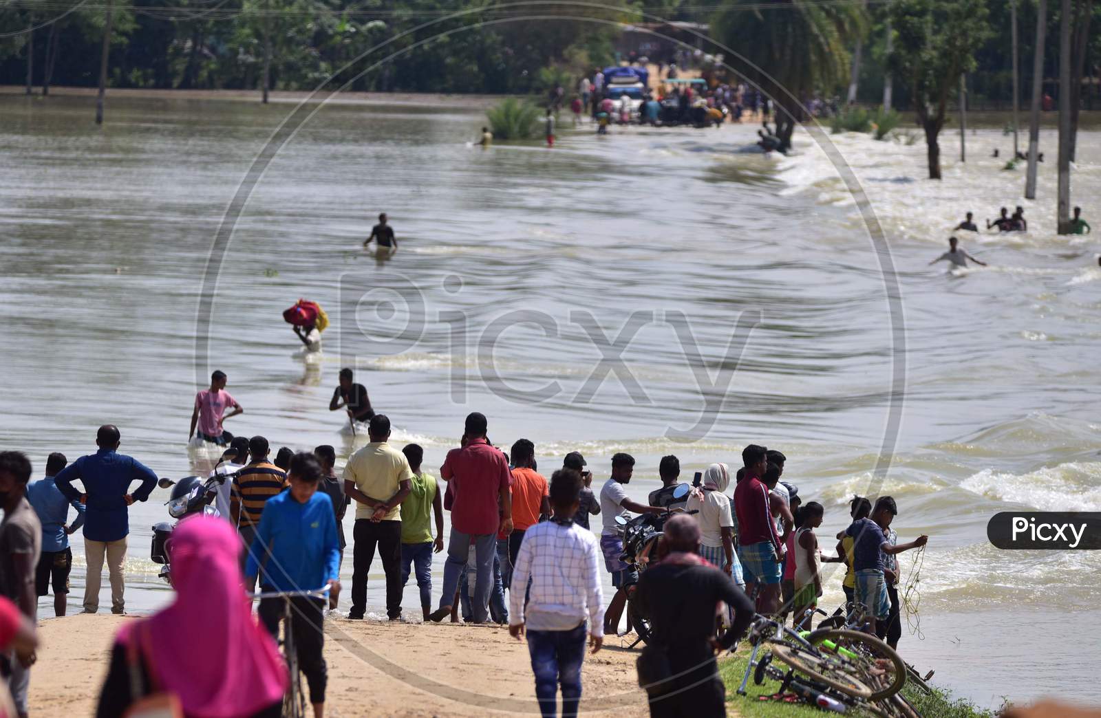 Villagers Stand Near A Flooded Street  At A Flood-Affected Jamunamukh  Village In Hojai District Of Assam On May 29,2020.