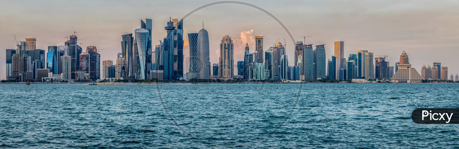 Doha skyline in Cor niche daylight view with clouds in the sky