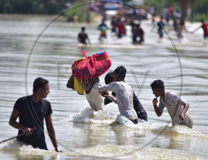 Villagers  Carrying Their Belongings Shift To A Safer Place At  Flood-Affected Jamunamukh  Village In Hojai District Of Assam On May 29,2020.