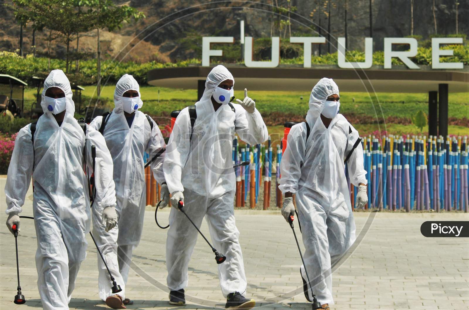 Workers wearing protective suits on their way to disinfect slum area and a temple as a preventive measure against the spread of coronavirus disease (COVID-19) in Mumbai, India on March 28, 2020.