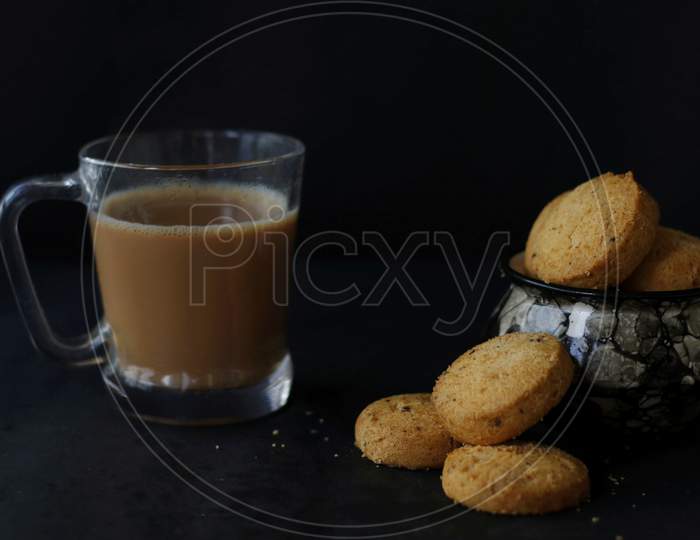 Biscuits Made Of Wheat Served In A White Basket With A Cup Of Tea.