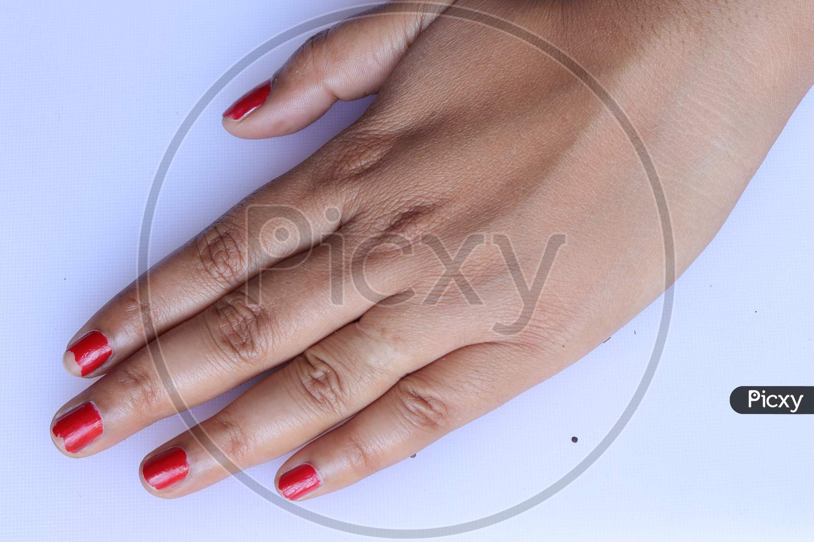 Two woman hands with red manicure. Isolated on white background.