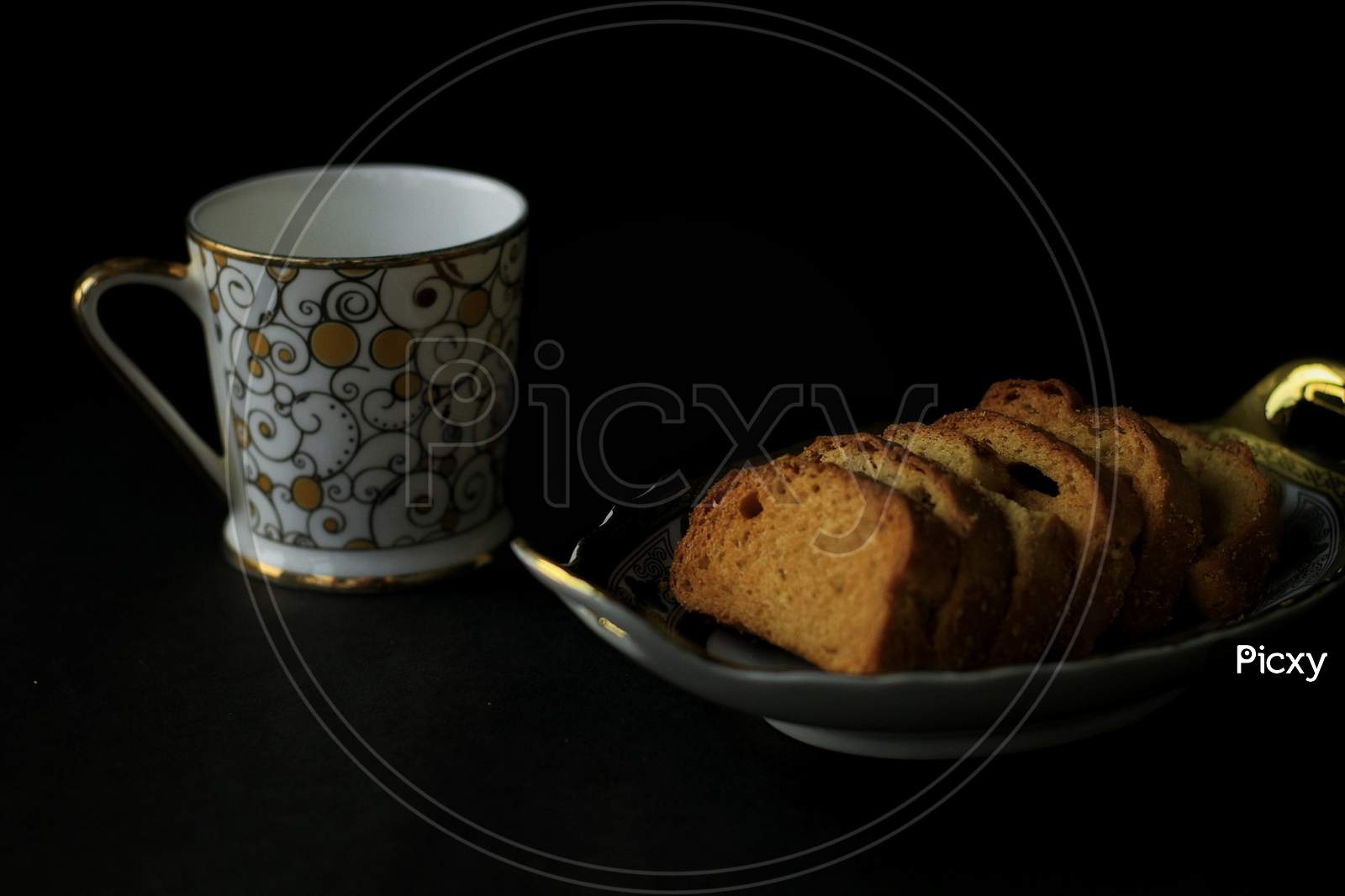 Toast Served On A Plate With A Cup Of Tea With Black Background