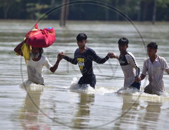 Villagers  Carrying Their  Belongings as they Shift To A Safer Place At  Flood-Affected Jamunamukh  Village In Hojai District Of Assam On May 29,2020