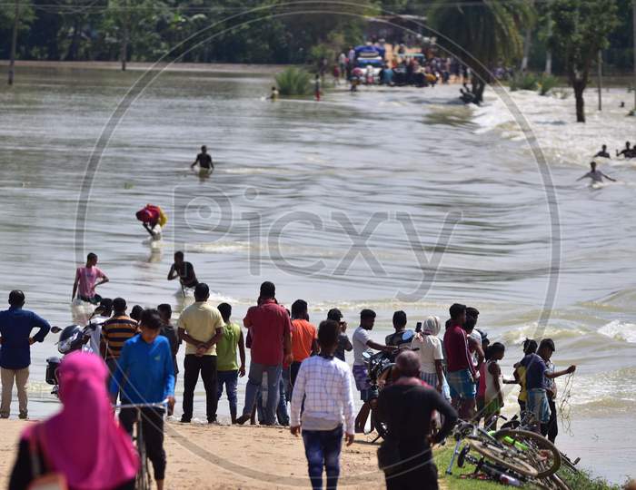 Villagers Stand Near A Flooded Street  At A Flood-Affected Jamunamukh  Village In Hojai District Of Assam On May 29,2020.