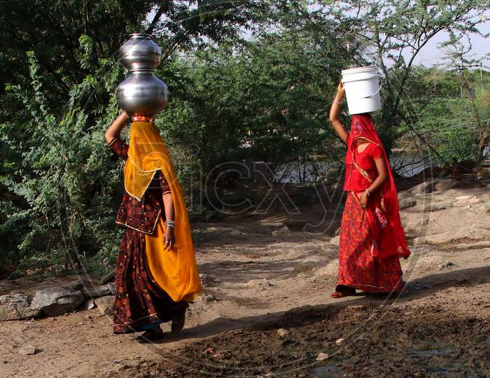 Rajasthani Village Women Collect Drinking Water On a Hot Summer Day On The Outskirts Of Ajmer, In The Indian State Of Rajasthan On May 29, 2020.