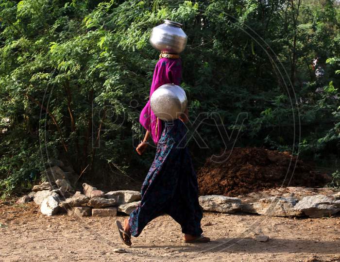 A Rajasthani Village Woman Collects Drinking Water During Hot Summer Day On The Outskirts Of Ajmer, In The Indian State Of Rajasthan On May 29, 2020.