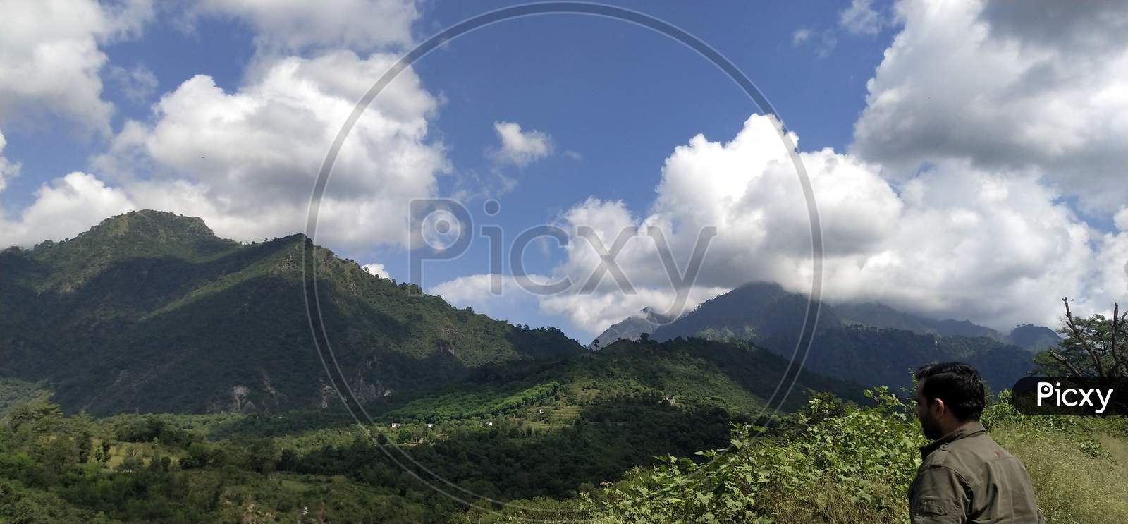 Green mountains landscape with coluds and blue sky