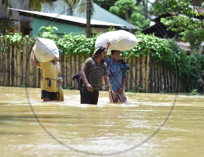 Villagers  Carrying Their Belongings Shift To A Safer Place During Floods At Kampur  In Nagaon District Of Assam On , May 29, 2020.