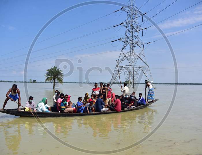 Flood Affected Villagers Arrive At A Safer Place On A Country Boat At  Jamunamukh  Village In Hojai District Of Assam On May 29,2020.