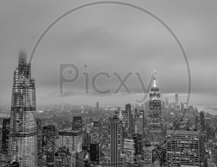 New York skyline from the top of  the Rock (Rockefeller Center)sunset view in Winter with clouds in the sky in black and white