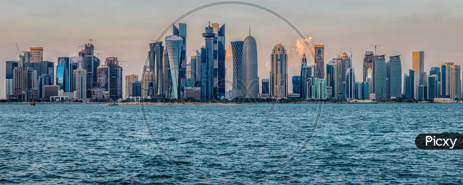 Doha skyline in Cor niche daylight view with clouds in the sky