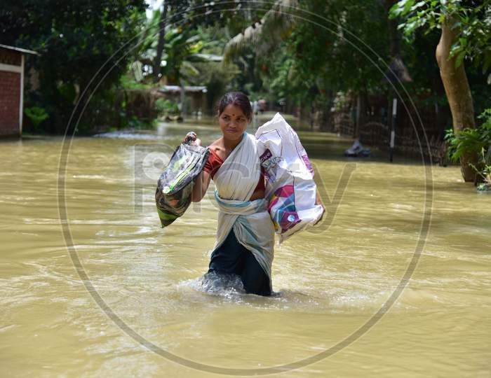 A woman Carrying Her  Belongings Shifts To A Safer Place During Floods At Kampur  In Nagaon District Of Assam On , May 29, 2020.