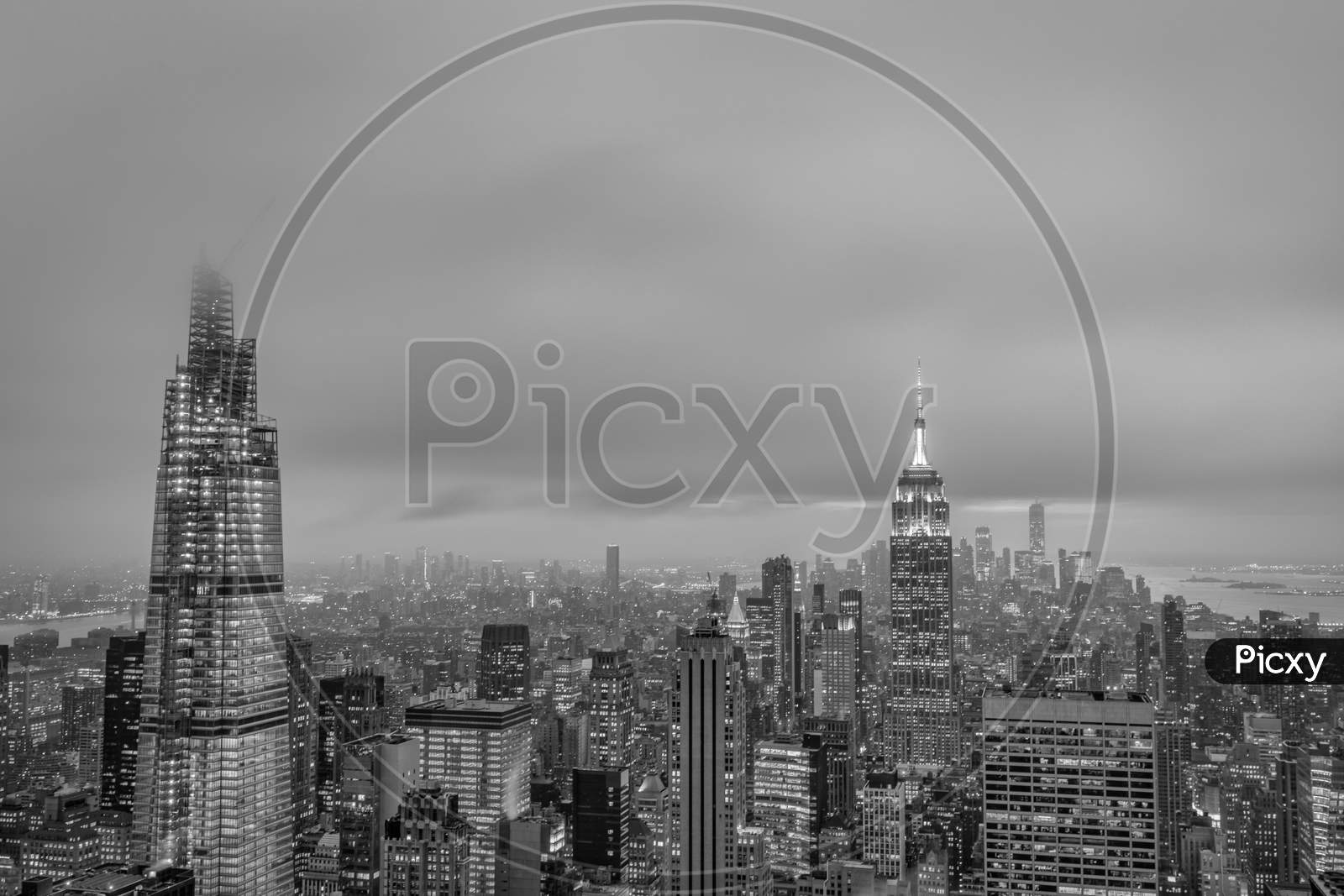 New York skyline from the top of  the Rock (Rockefeller Center)sunset view in Winter with clouds in the sky in black and white