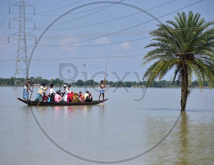 Flood Affected Villagers Being transported On A Country Boat At  Jamunamukh  Village In Hojai District Of Assam On May 29,2020.