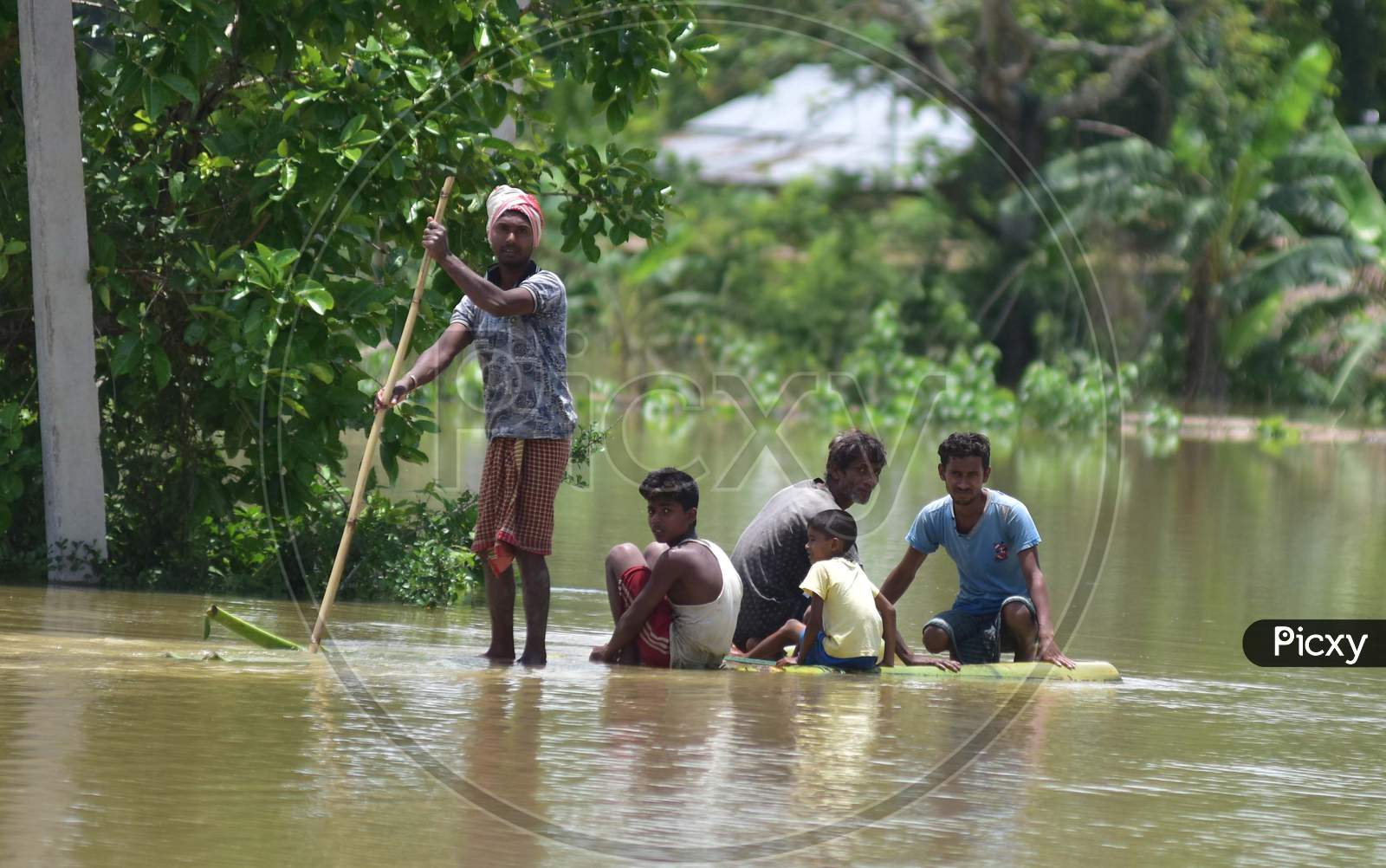 Villagers Row A Makeshift Banana Raft in Kampur In Nagaon District Of Assam On May 29,2020.