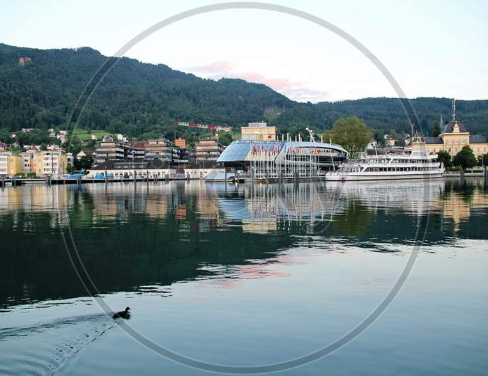 Bregenz Harbour With Reflecting Green Water And Ships