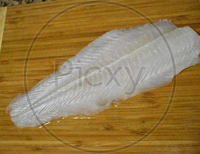 Fish Fillet In A Wooden Board Before Cooking.
