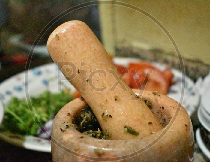Traditional Wooden Mortar And Tomato,Vegetable In The Background
