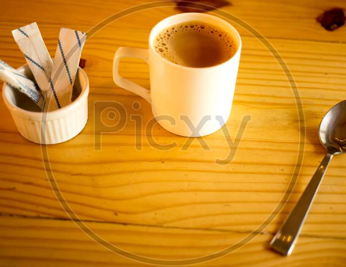 Coffee cup With sugar and spoon in  Cafe