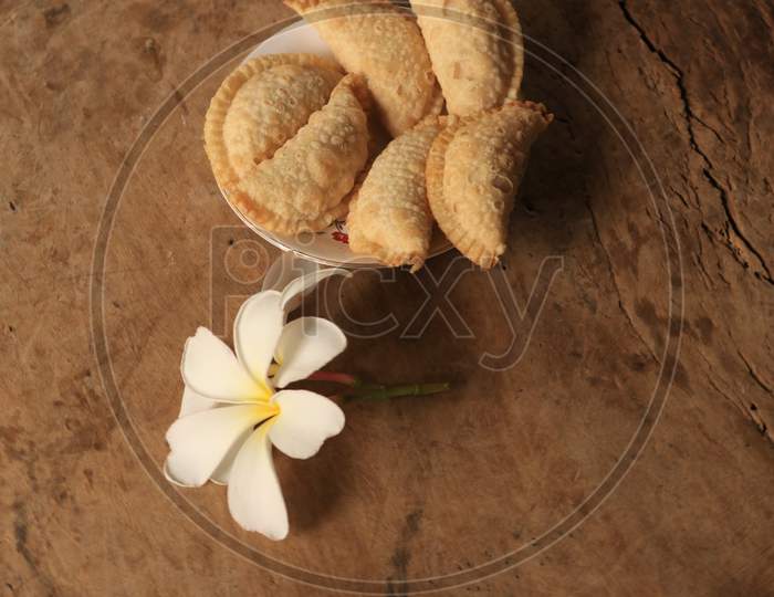 Indian Sweet Savory Kajjikayalu made With Flour And Jaggery  On Isolated Background