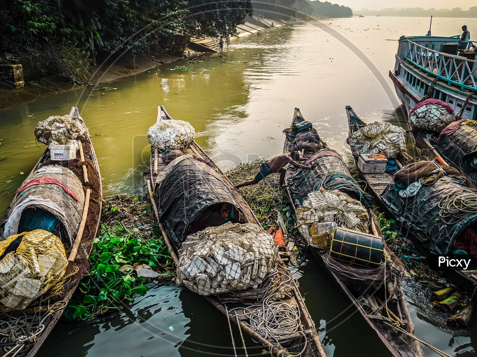 Boats are tied together on Ganges River, Polluted water of river in city, garbage on river. landscape view of Ganges river