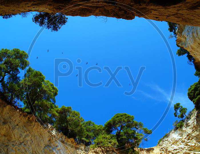 Sky view through natural cave hole Grotta Sfondata in natural area of Gargano National Park