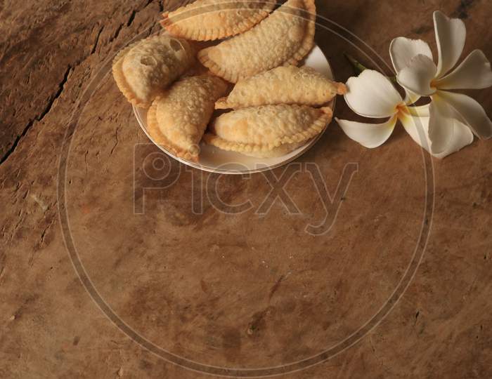 Indian Sweet Savory Kajjikayalu made With Flour And Jaggery  On Isolated Background