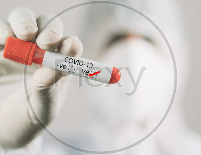 Doctor Hand Holding Negative Sample Blood Test Tube Of Coronavirus, Covid-19 Or 2019-Ncov In Laboratory.