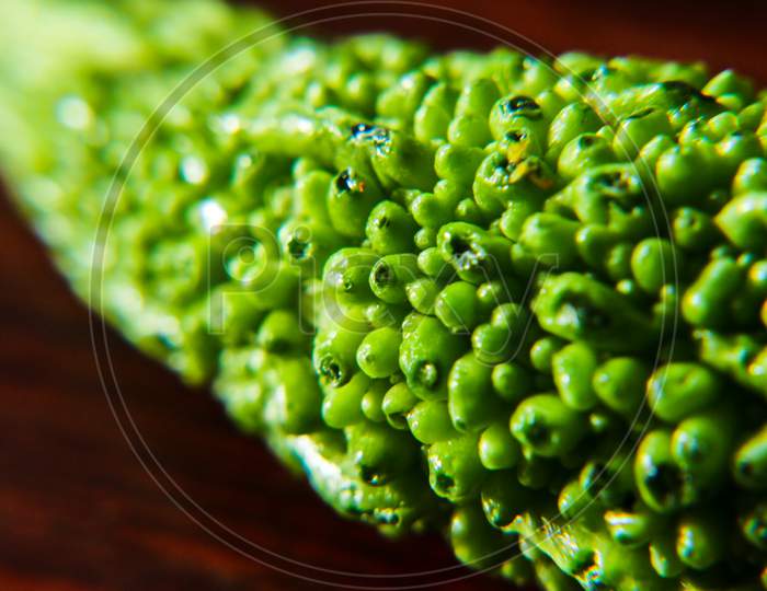 Close up photo of bitter gourd, a fresh green healthy vegetable with bitter taste. Upper texture of bitter gourd. Macro photography of vegetable