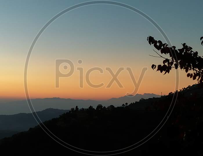 Orange color evening sunset landscape in hilly area of Himachal pradesh, India
