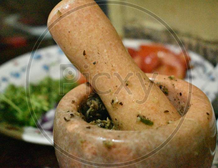 Traditional Wooden Mortar And Tomato,Vegetable In The Background