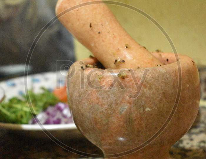 Traditional Wooden Mortar And Tomato,Vegetable In The Background.